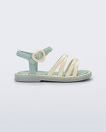 Side view of a green Aurora baby sandal with beige trim, straps and buckle
