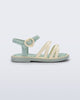 Side view of a green Aurora baby sandal with beige trim, straps and buckle