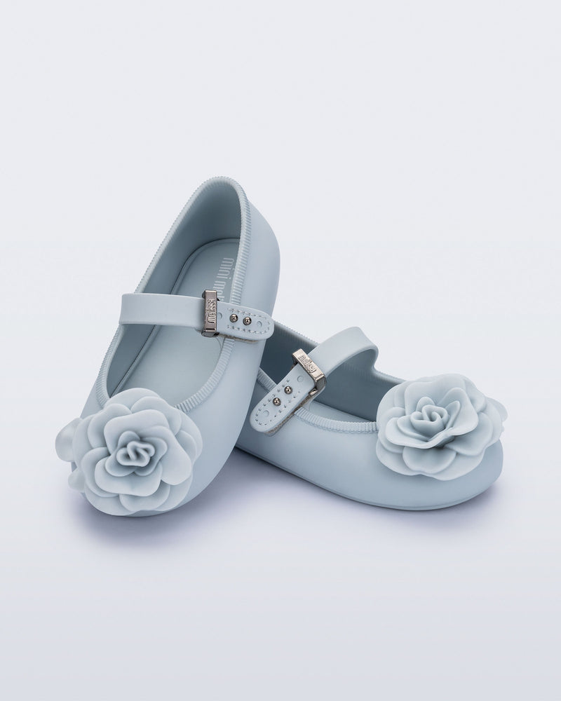 Angled view of a pair of blue Soft Ballerina baby flats with blue flowers