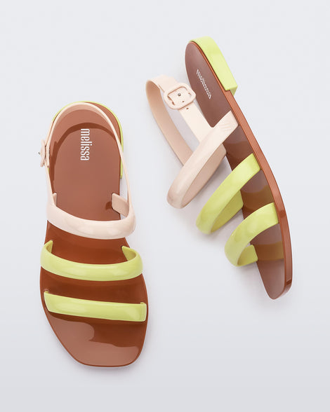 Side and top view of a pair of beige and yellow Essential Wave women's sandal with adjustable buckle.