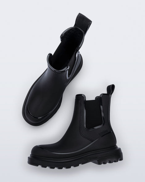 Top and side view of a pair of black Noir Boots with black soles