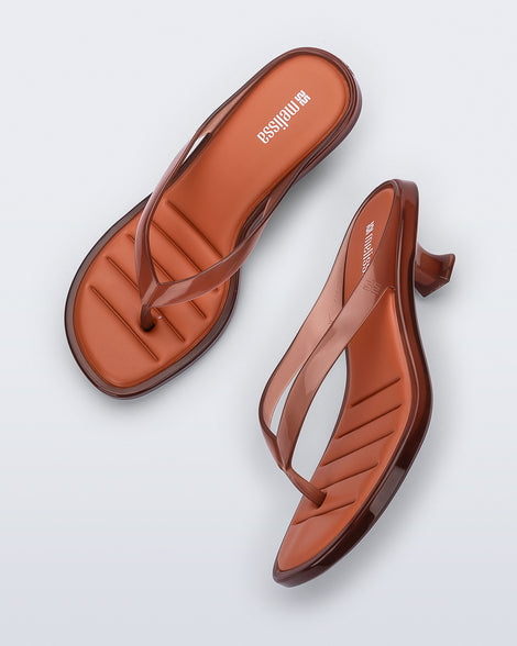 Top and side view of a pair of brown Flip Flop Kitten Heels with clear brown straps