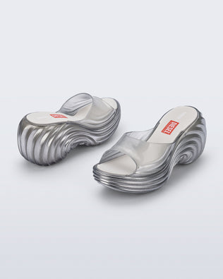 Side and back angled view of a pair of clear silver Quantum Platform sandals