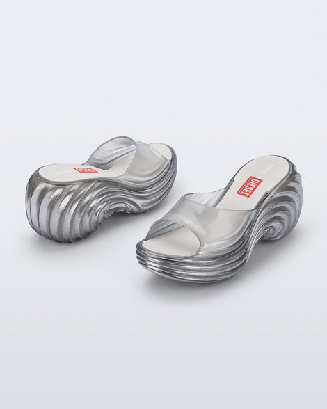 Side and back angled view of a pair of clear silver Quantum Platform sandals