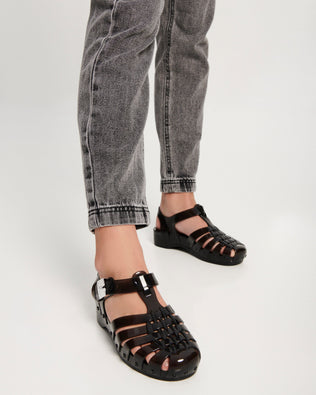 Model's legs wearing a pair of black Possession Pescura + Scholl fisherman sandals