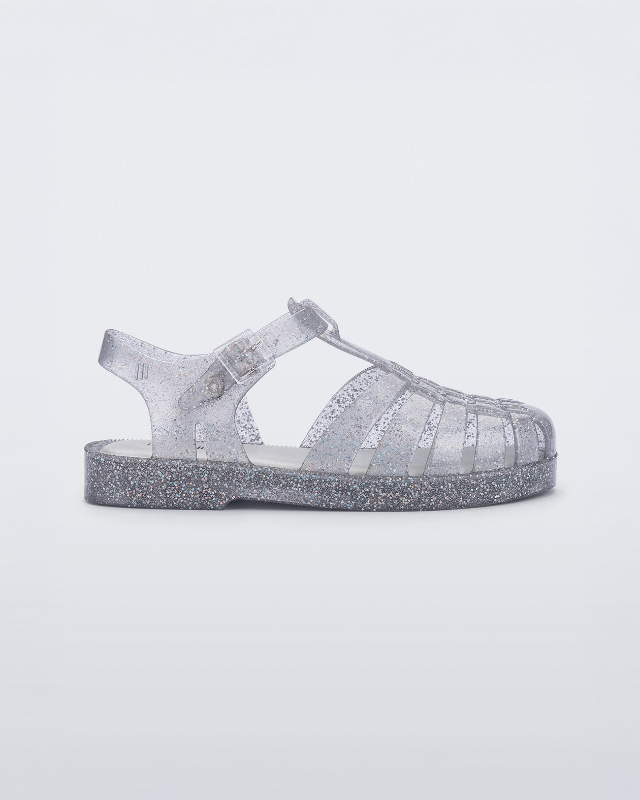 Side view of a glitter/clear/silver Possession kids fisherman sandal