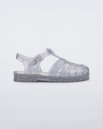 Side view of a glitter/clear/silver Possession kids fisherman sandal