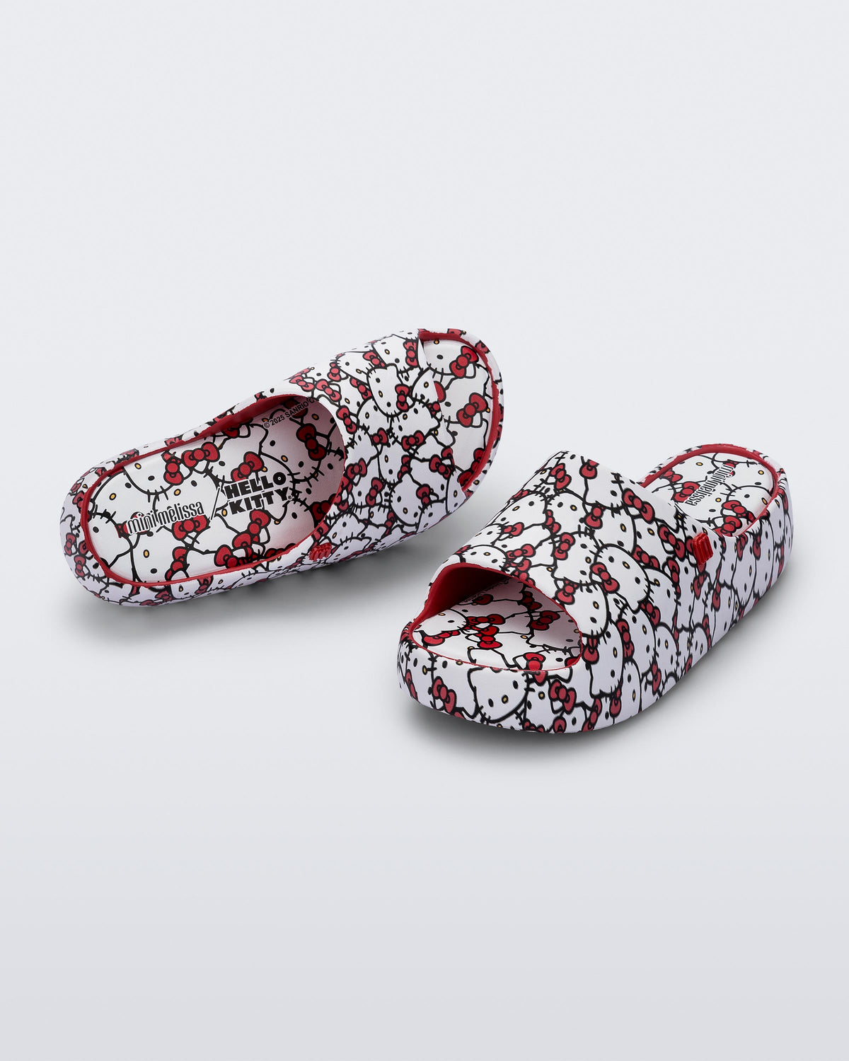 Top and angled view of a pair of red Free Platform slides + Hello Kitty and Friends kids sandals with Hello Kitty print