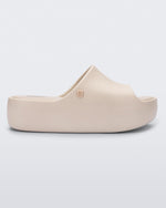 Side view of the beige Free Platform women's slide