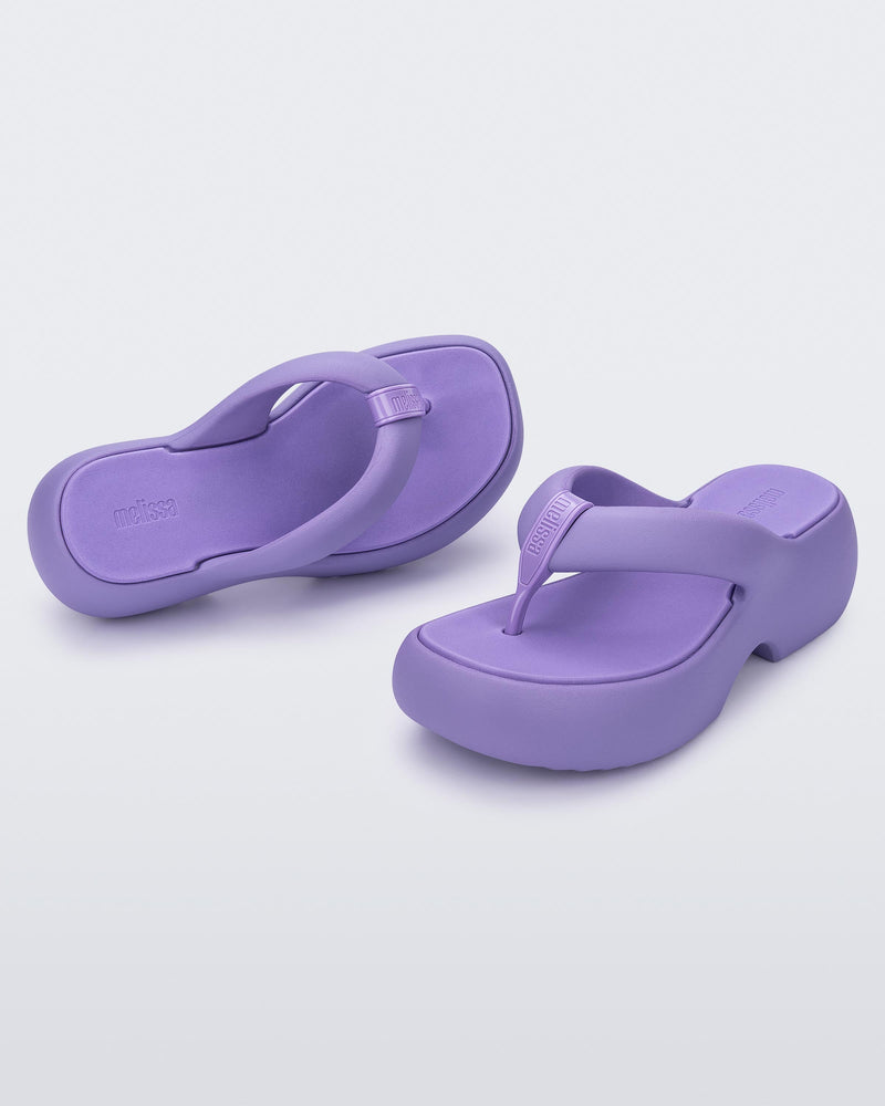 Top and angled view of a pair of lilac Free Platform II flip flops