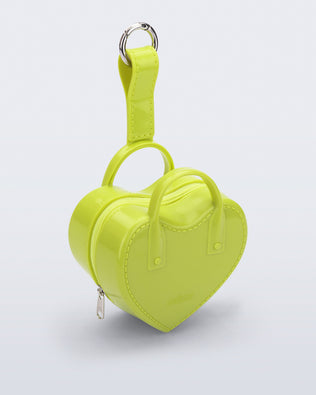 Angled view of a green Heartbeat Pocket bag charm