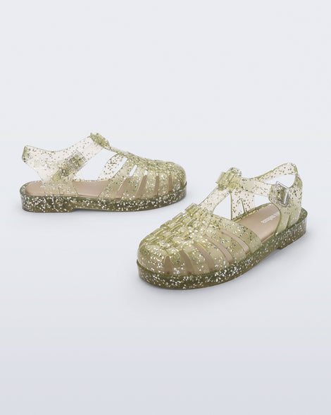 Side and angled view of a pair of yellow Possession kids sandals with heart glitter