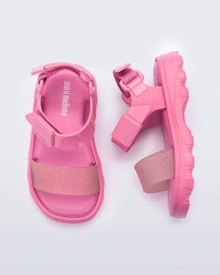 Top and side view of a pair of pink baby Kick Off Sandals