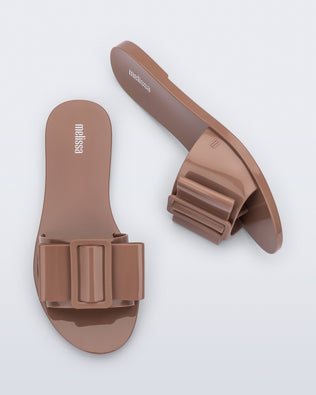 Top and side view of a pair of tan Babe slide sandals