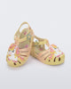 Angled view of a pair of yellow/pink Possession Unicorn baby sandals with unicorn on front upper