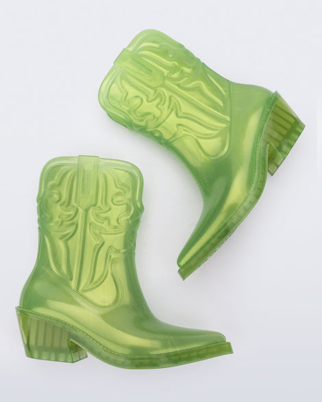 Side view of a pair of pearly green Texas boots with pointed toe.
