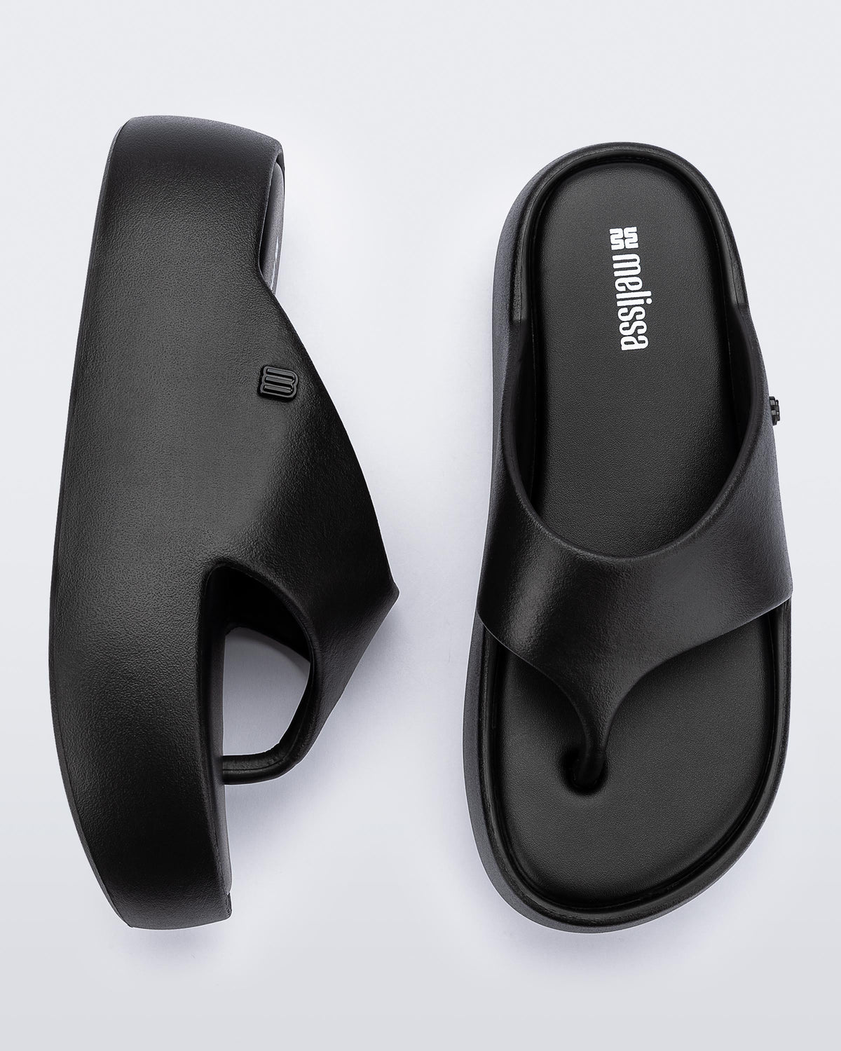 Side and angled view of a pair of black Free Platform Thong sandal