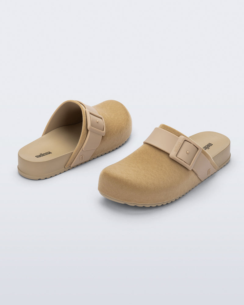 Back and front angled view of a pair of beige Cozy Clog Velvet slides