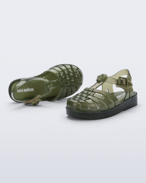 Angled and top view of a pair of clear green Possession baby sandals