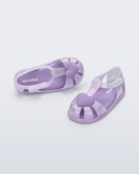 Side and top view of a pair of lilac Hip Heart Ballerina baby sandals with heart on front