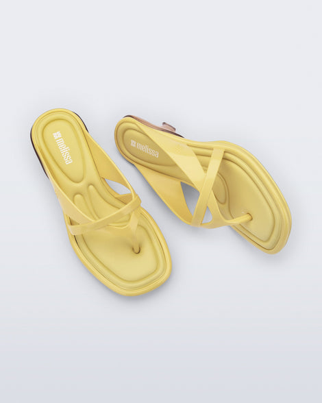 Top and side view of a pair of yellow Layla kitten heel flip flops