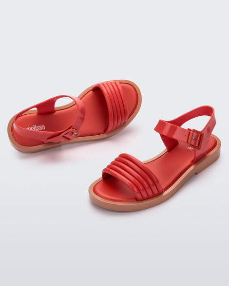 Angled view of a pair of red Mar Wave women's sandals with beige sole.