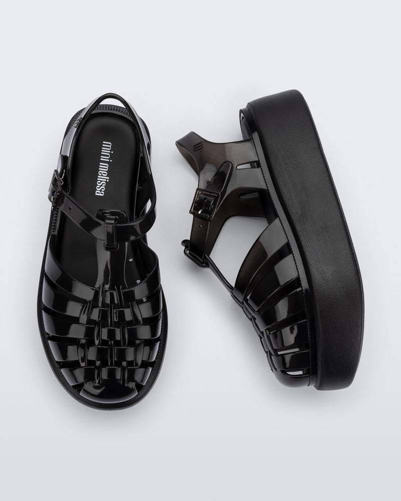 Top and side view of a pair of black Possession Platform kids fisherman sandals
