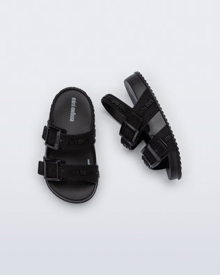 Top and side view of a pair of black Cozy M Lover baby sandals