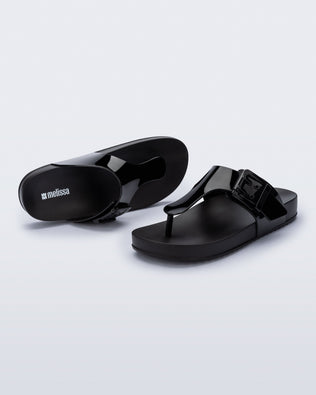 Top and angled view of a pair of black Cozy Flip flops