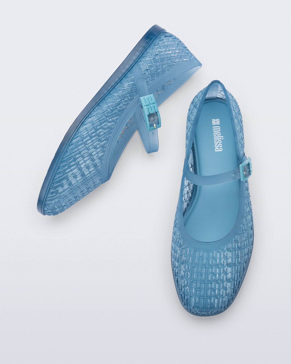 Top and side view of a pair of transparent blue Harper flats