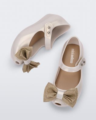 Top and side view of a pair of beige Ultragirl Sweet baby ballerina flats