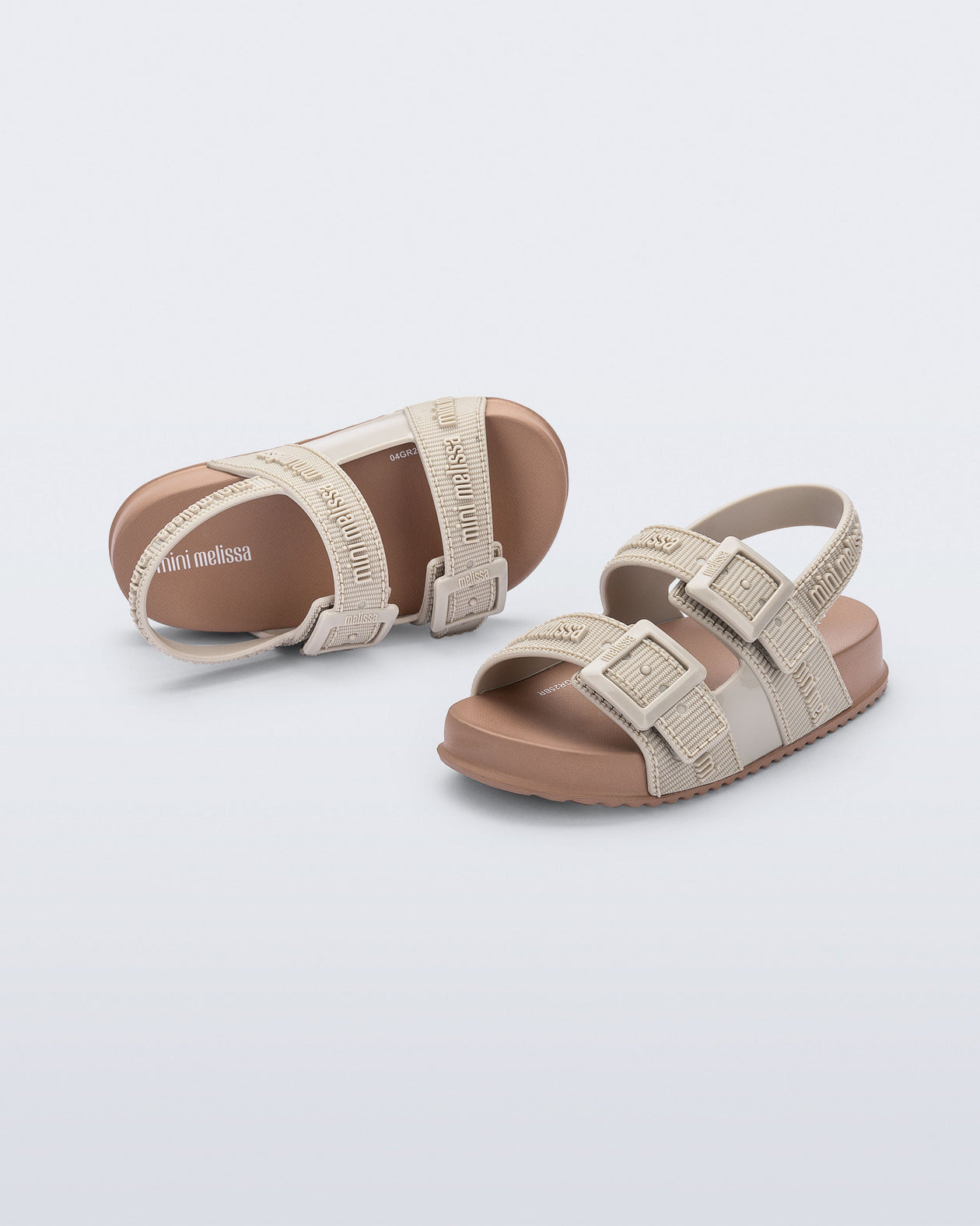 Top and angled view of a pair of beige Cozy M Lover baby sandals