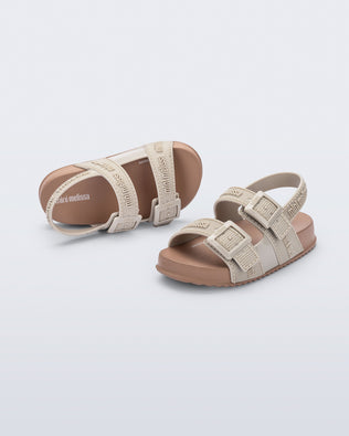 Top and angled view of a pair of beige Cozy M Lover baby sandals