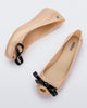 Top and side view of a pair of beige Ultragirl Bow flats with black bow.