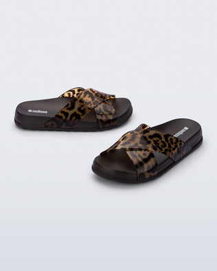 Side and angled view of a pair of dark brown/tortoise Cozy Cross sandals with crisscross top straps
