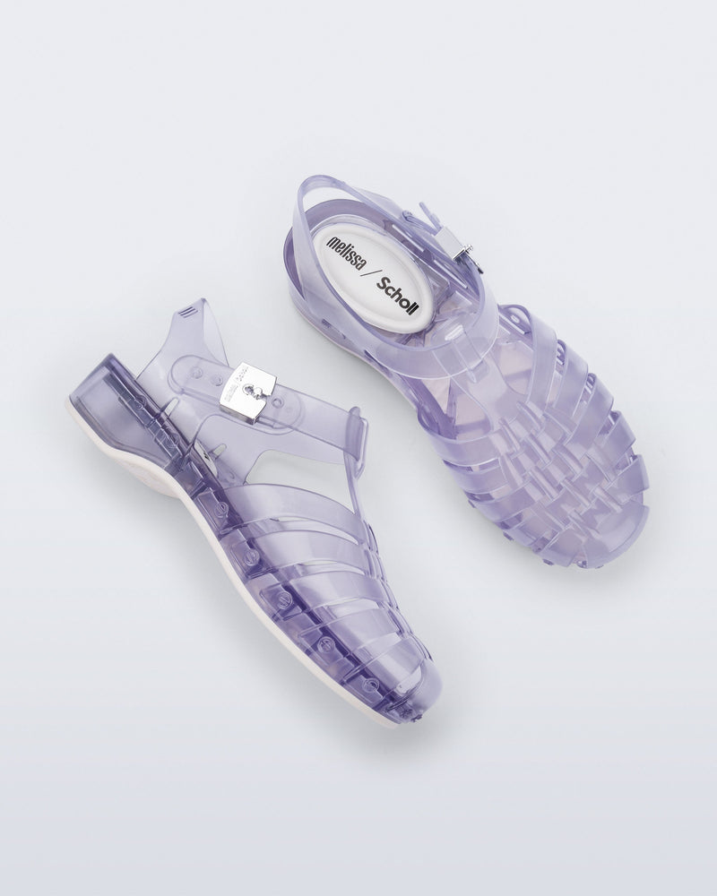 Side and top view of a pair of clear Possession Pescura + Scholl fisherman sandals with white bottom sole