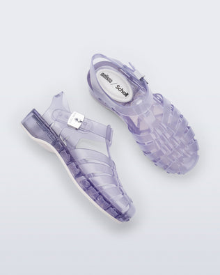 Side and top view of a pair of clear Possession Pescura + Scholl fisherman sandals with white bottom sole