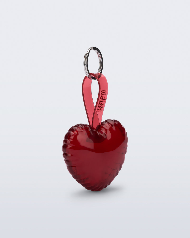 Angled view of a red Heart bag charm