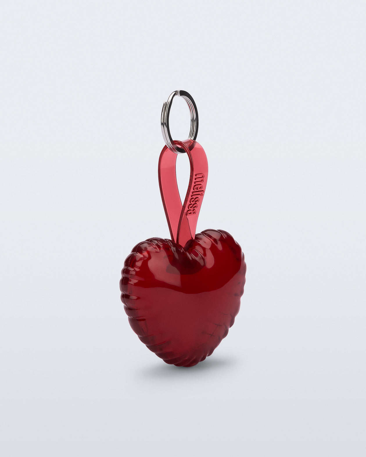 Angled view of a red Heart bag charm