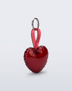 Angled view of a red Heart bag charm