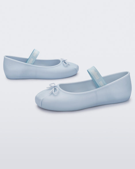 Angled view of a pair of Melissa Sophie ballet flats in blue with M-logo strap and bow applique