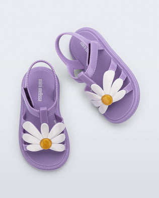 Top view of a pair of purple Hip Bloom sandals with a white flower on top