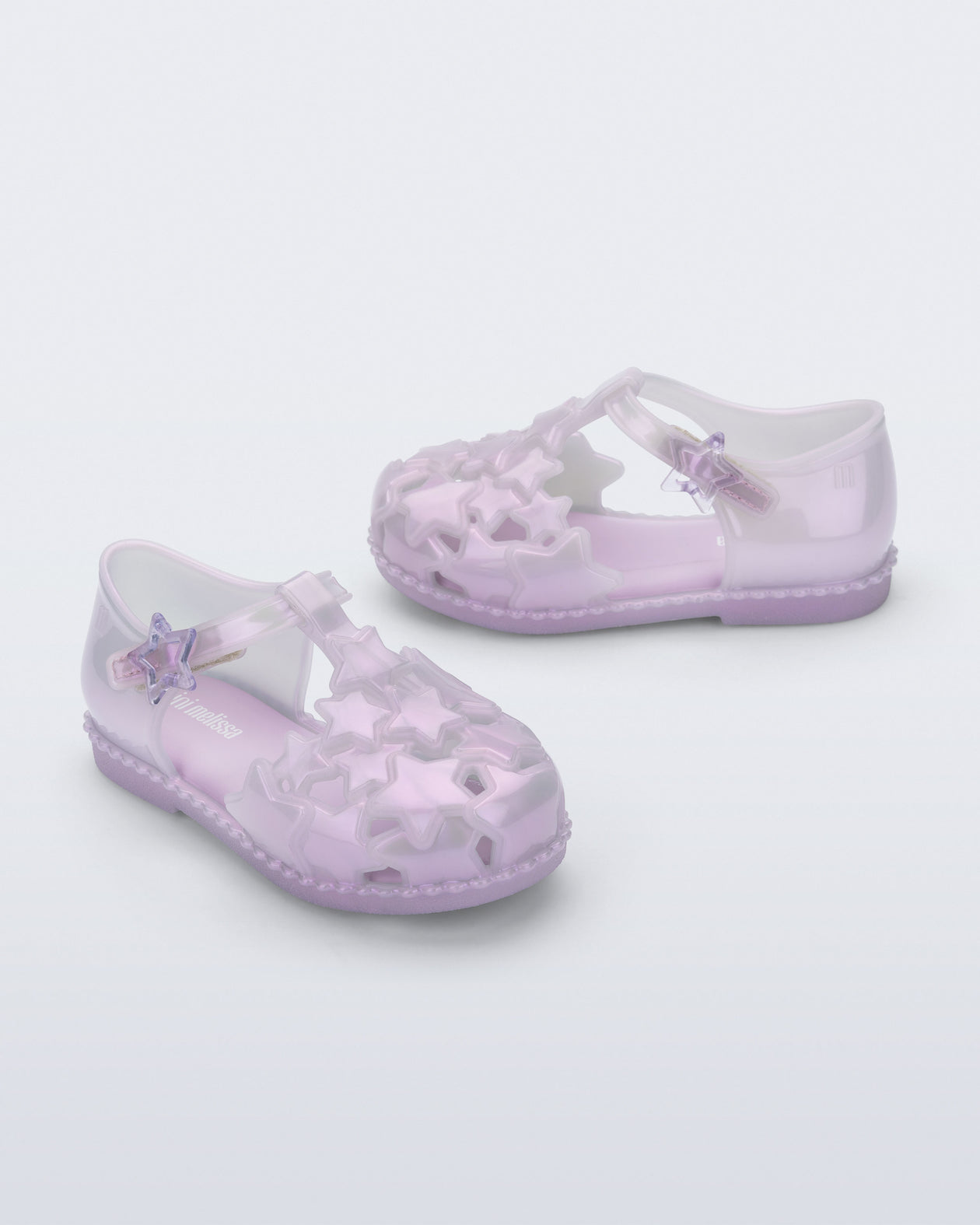 Side and angled view of a pair of pearly lilac Starry baby sandals