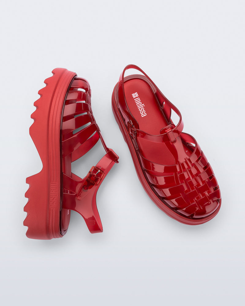 Top and side view of a pair of transparent red Possession Platform II sandals