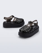 Back and angled view of a pair of black Possession Platform kids fisherman sandals