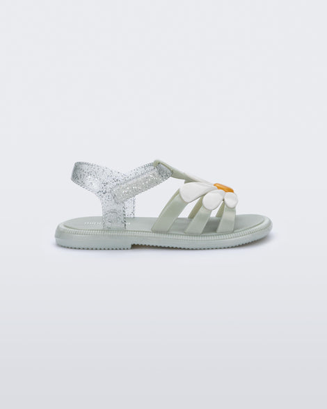 Side view of a metallic green Hip Bloomy baby sandal with white daisy on top