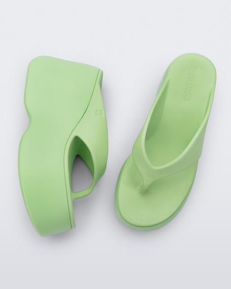 Top and side view of a pair of green Free Thong  Wedge Platform heels
