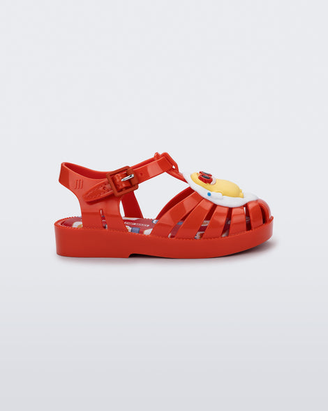 Side view of a red Possession + Pop Mart Pucky fisherman baby sandal