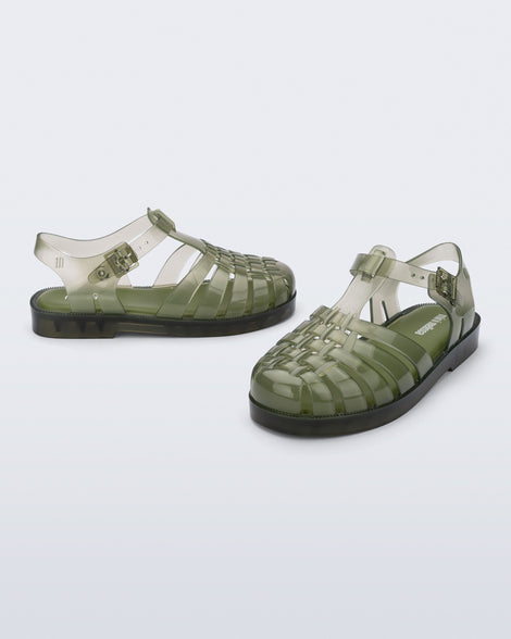 Side and angled view of a pair of transparent green Possession kids sandals