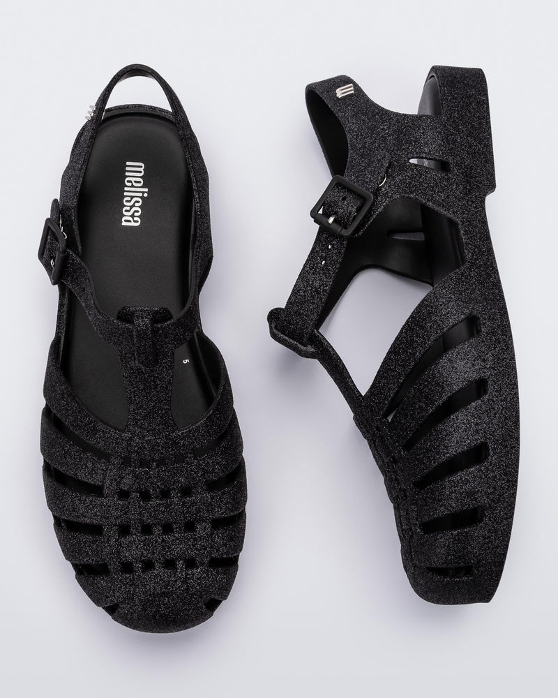 Top and side view of a pair of glitter black Possession fisherman sandal